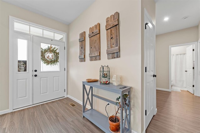 foyer entrance with light hardwood / wood-style flooring