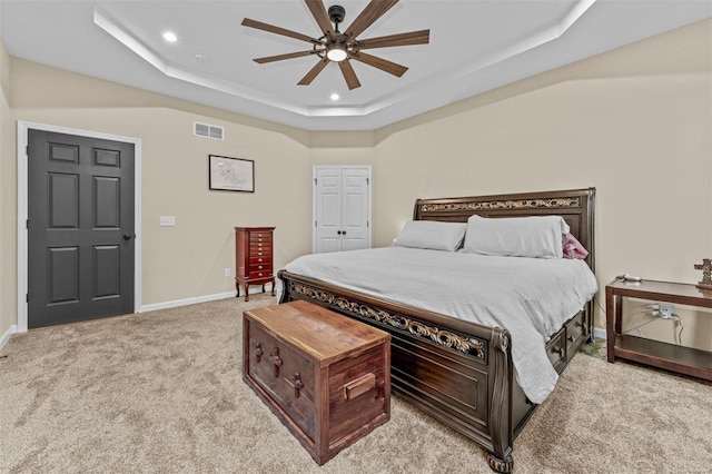 bedroom featuring recessed lighting, a raised ceiling, visible vents, light carpet, and baseboards