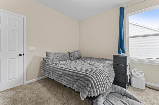 bedroom with carpet floors, visible vents, and baseboards