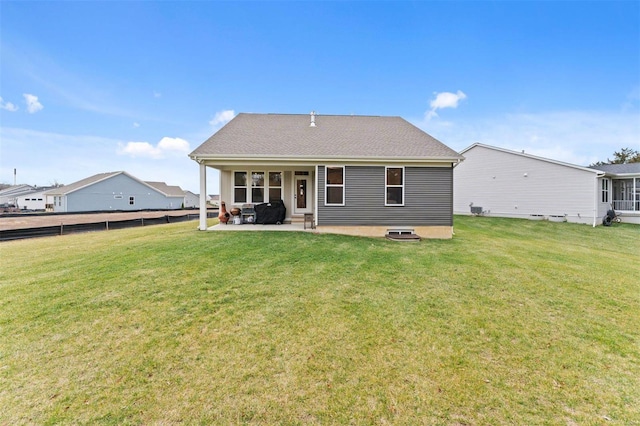 back of house with a patio area, fence, and a lawn