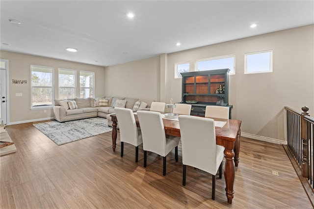 dining space with light wood-type flooring, baseboards, and recessed lighting