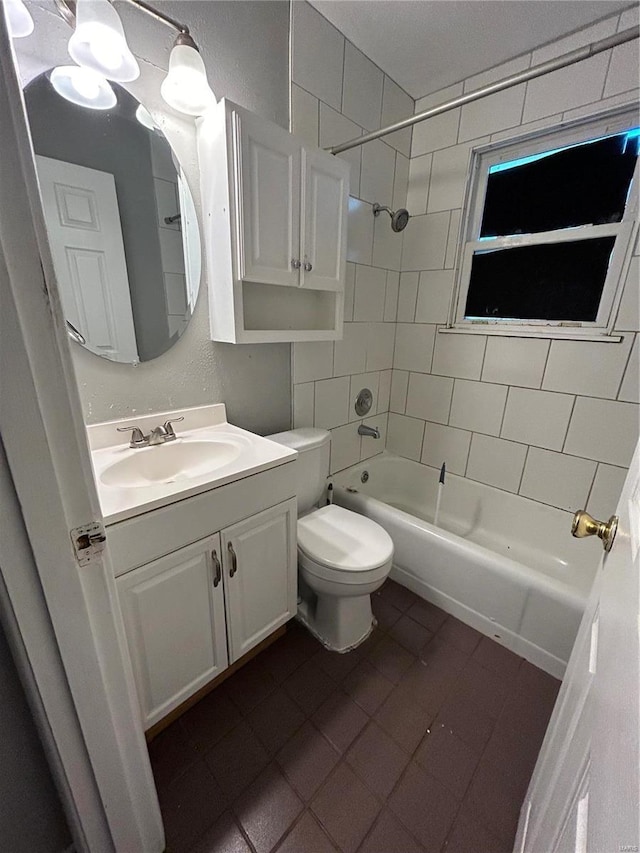 full bathroom featuring tile patterned floors, toilet, vanity, and tiled shower / bath