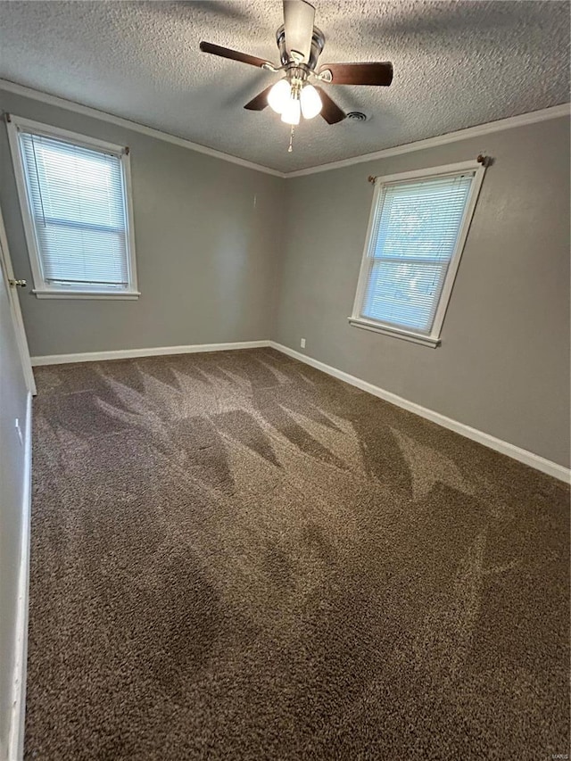 carpeted empty room featuring ornamental molding and a textured ceiling