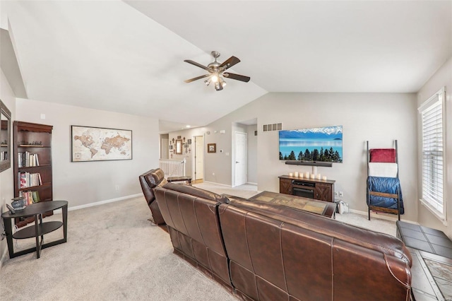 carpeted living room with vaulted ceiling and ceiling fan