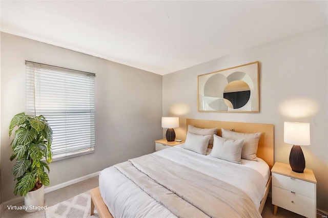 bedroom featuring light carpet and multiple windows