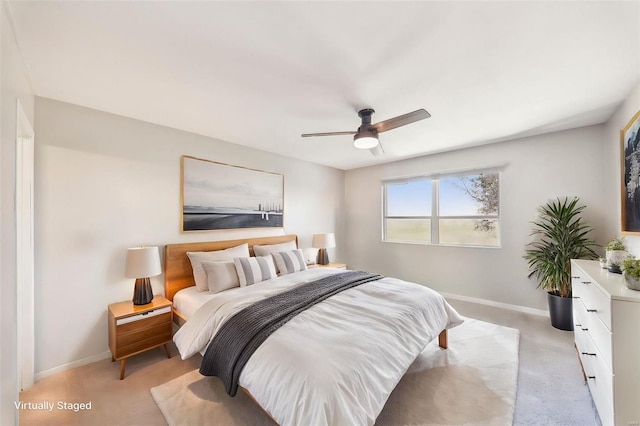 bedroom with ceiling fan and light carpet