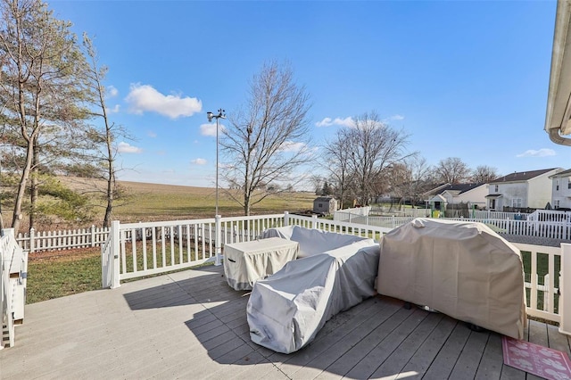 wooden terrace featuring a grill