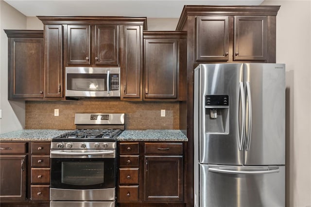 kitchen with decorative backsplash, appliances with stainless steel finishes, dark brown cabinetry, and light stone countertops