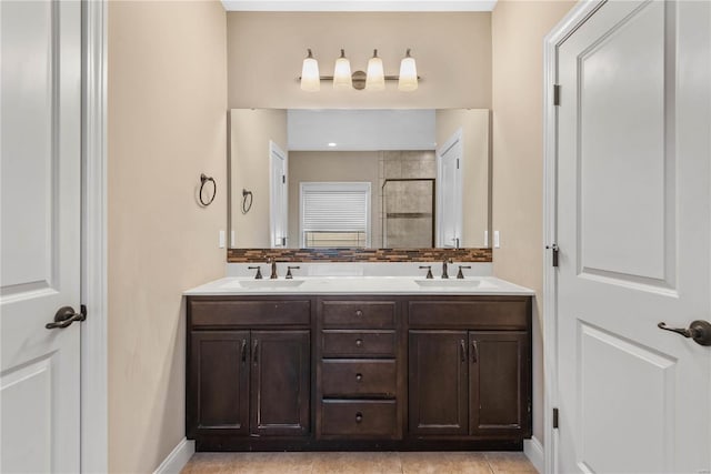 bathroom with tile patterned flooring, vanity, and a shower