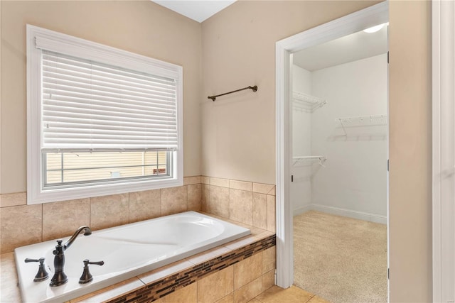 bathroom featuring tiled bath and tile patterned flooring