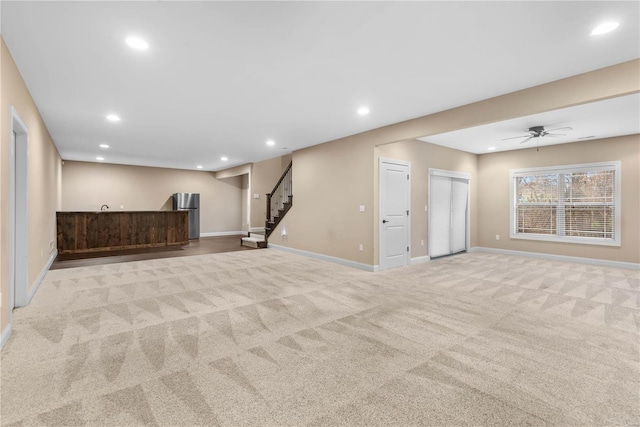 basement with light carpet and ceiling fan