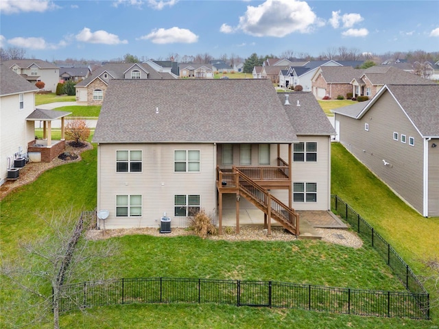 back of property with central air condition unit, a lawn, and a deck