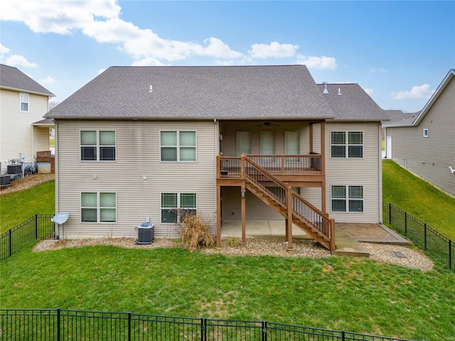 back of house featuring a lawn, cooling unit, a deck, and a patio