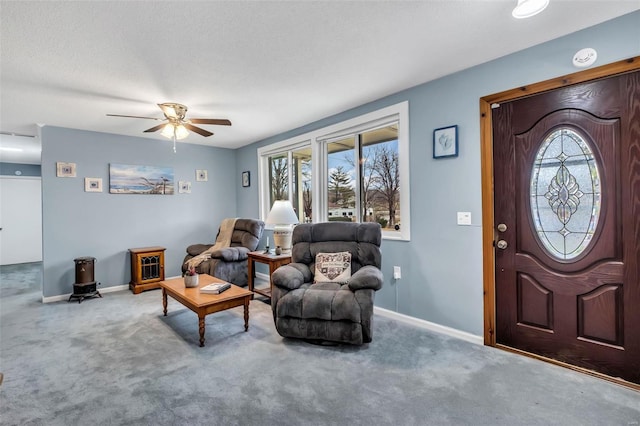 interior space with carpet flooring, a textured ceiling, and ceiling fan