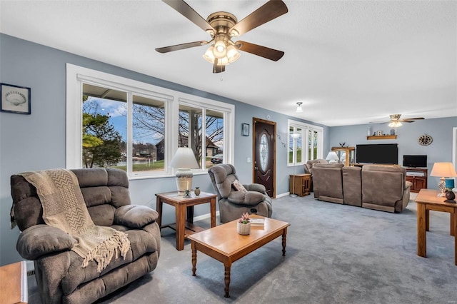 living room featuring carpet flooring and ceiling fan