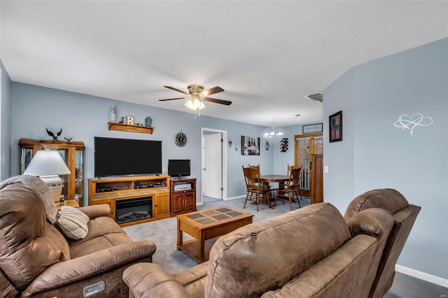 living room featuring carpet flooring and ceiling fan with notable chandelier