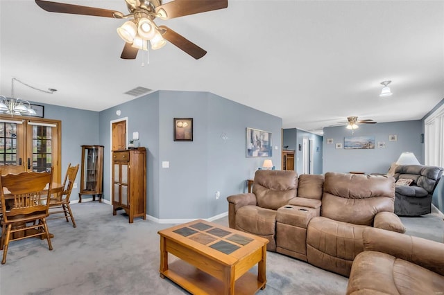 living room with light carpet and an inviting chandelier