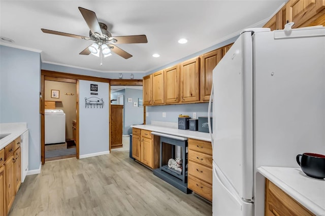 kitchen with light wood-type flooring, ceiling fan, crown molding, washer / dryer, and white fridge