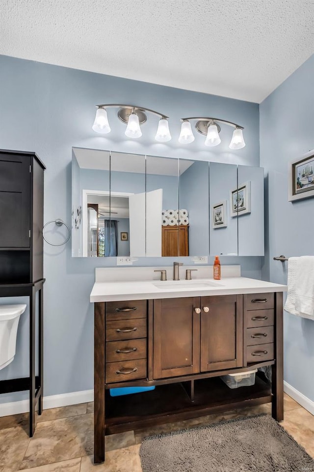 bathroom with vanity and a textured ceiling