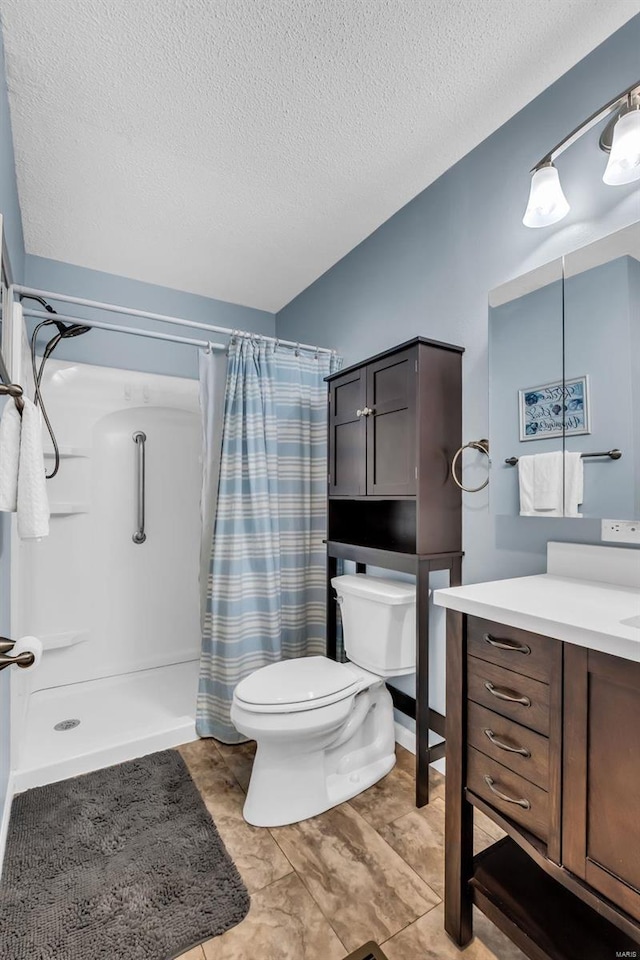 bathroom with curtained shower, vanity, a textured ceiling, and toilet