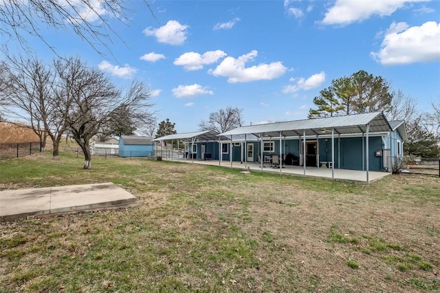 rear view of property with a yard