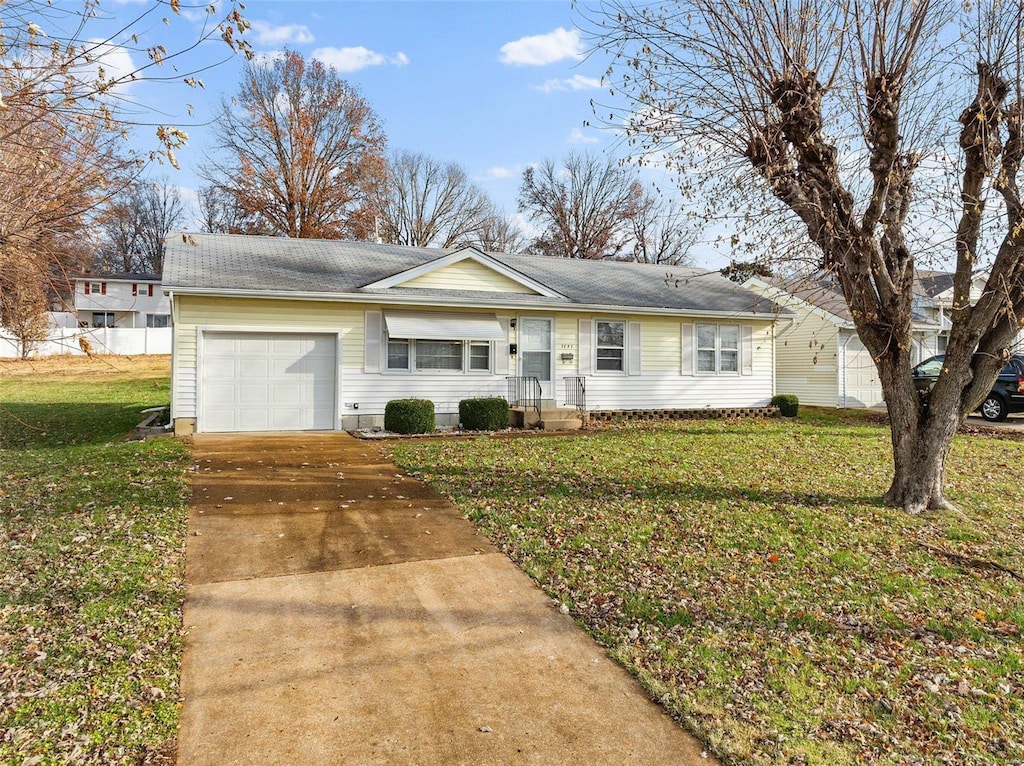 ranch-style home with a front yard and a garage