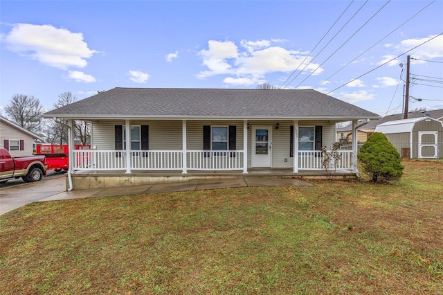 view of front facade featuring covered porch, a shed, and a front lawn