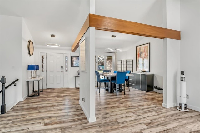 entrance foyer with vaulted ceiling with beams and wood-type flooring