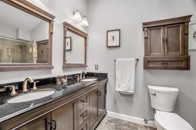 bathroom with vanity, toilet, a shower with shower door, and wood-type flooring