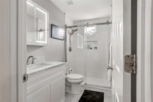 bathroom with a shower with door, vanity, and toilet