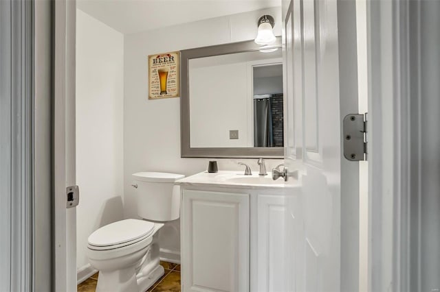 bathroom featuring tile patterned flooring, vanity, and toilet