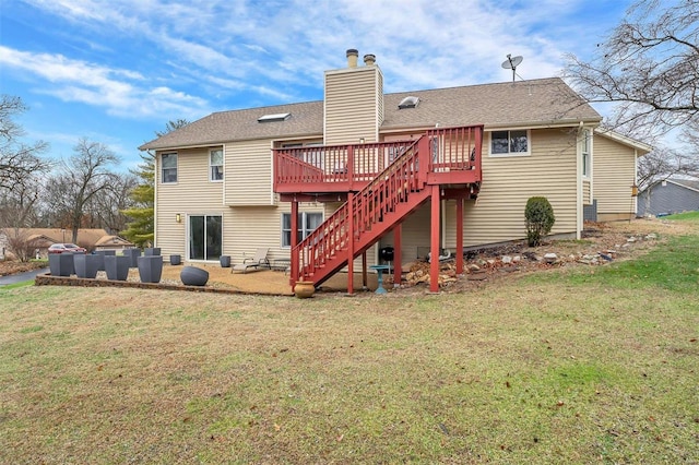 back of house featuring a lawn and a wooden deck