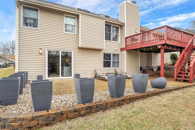 rear view of property featuring a wooden deck