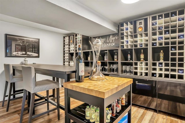 wine room with wood-type flooring