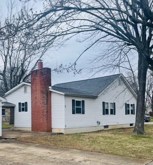 rear view of house with a yard