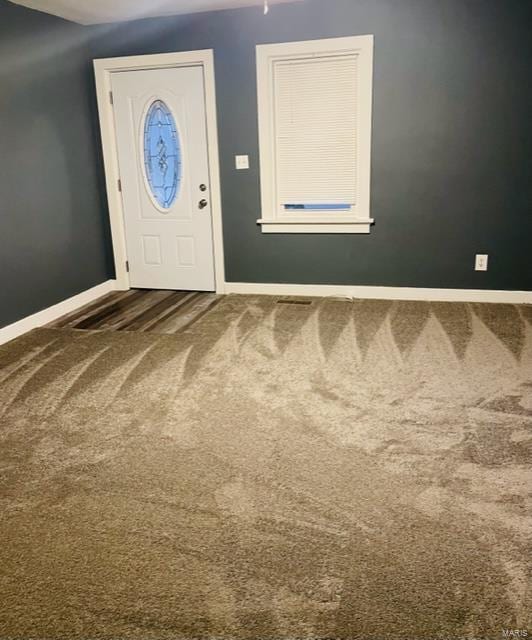 view of carpeted foyer entrance