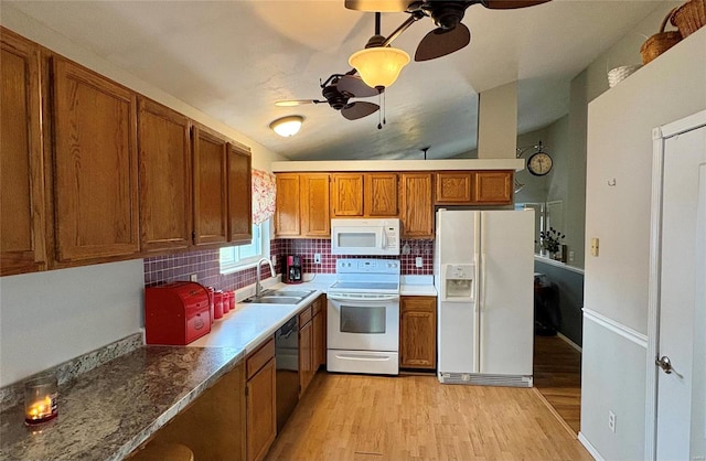 kitchen with white appliances, sink, light hardwood / wood-style flooring, ceiling fan, and tasteful backsplash