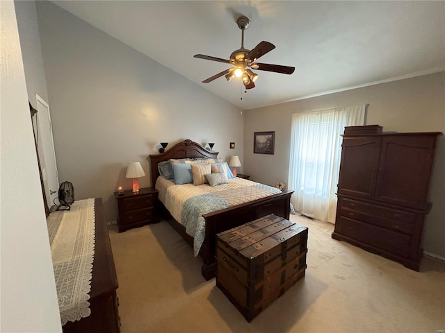 carpeted bedroom featuring ceiling fan and vaulted ceiling