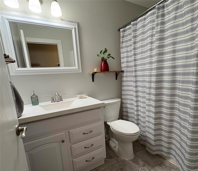 bathroom featuring vanity, toilet, and curtained shower