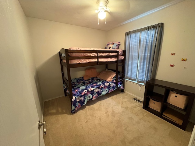 bedroom featuring ceiling fan, light colored carpet, and crown molding