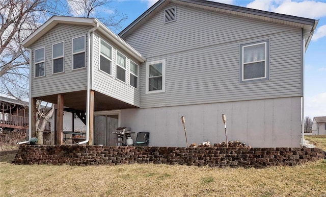 rear view of property featuring a yard