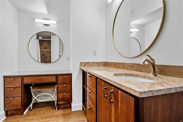 bathroom featuring vanity and hardwood / wood-style flooring