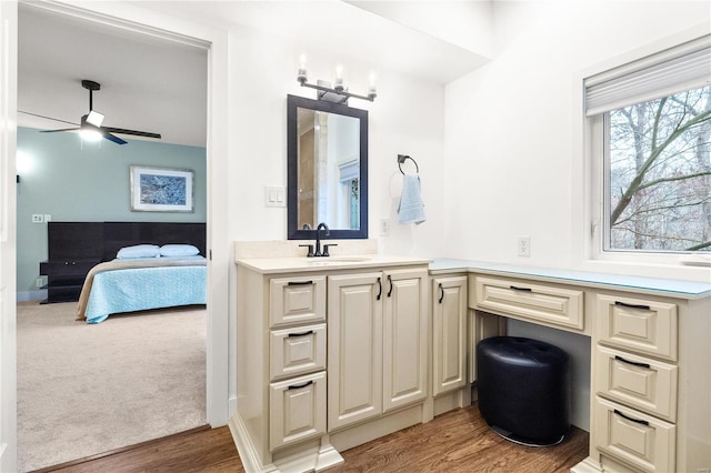 bathroom with ceiling fan, hardwood / wood-style floors, and vanity