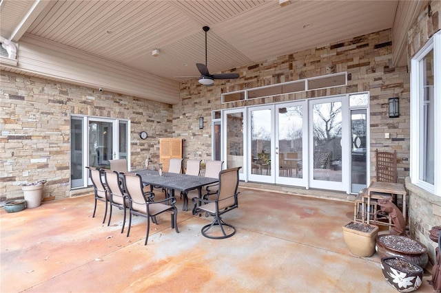 view of patio with ceiling fan and a fireplace