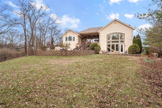 rear view of property with a yard