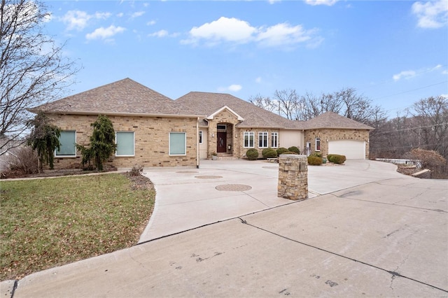 single story home with a front yard and a garage