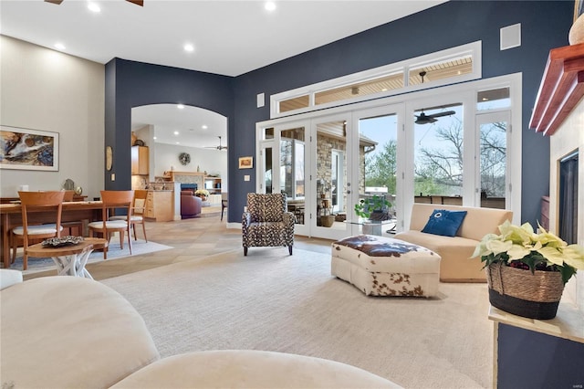 living room with ceiling fan and french doors