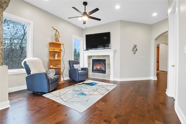 sitting room featuring a healthy amount of sunlight, dark hardwood / wood-style flooring, and a tile fireplace