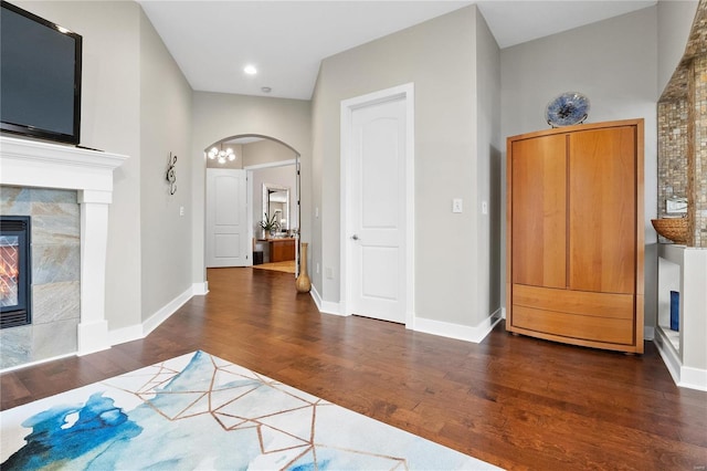 foyer entrance featuring a fireplace and dark hardwood / wood-style floors