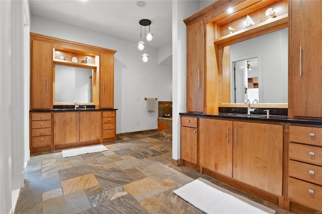 bathroom featuring ceiling fan and vanity